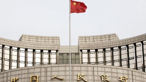 A Chinese flag flies in front of the People's Bank of China headquarters in Beijing, China. On Monday, the central bank said it is "almost ready" to release a digital currency that has been five years in development. Giulia Marchi—Bloomberg via Getty Images